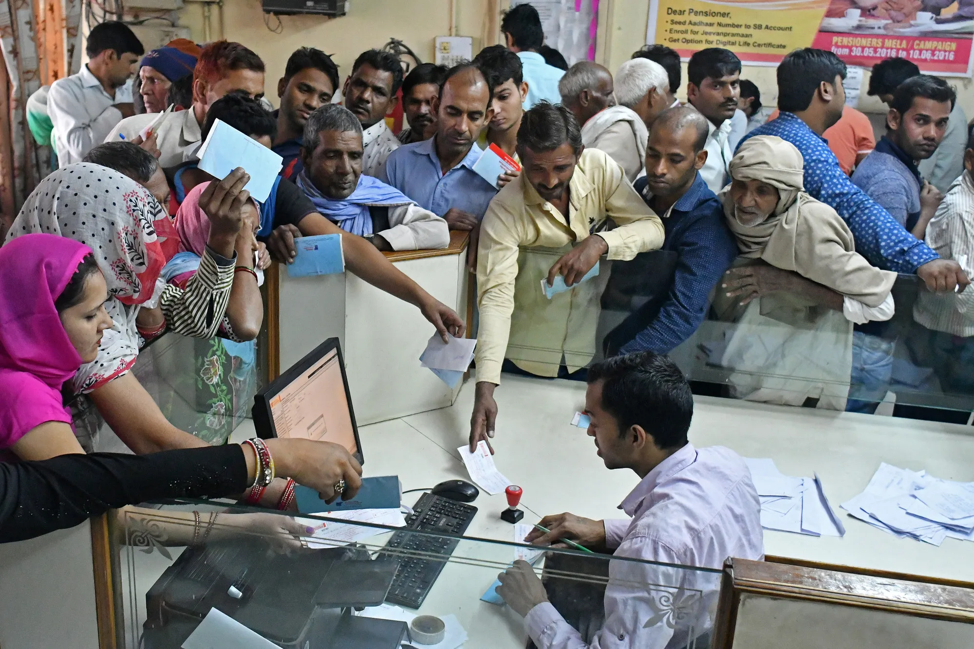Customers wait to exchange Indian five hundred and one thousand rupee banknotes at a bank in India on Nov. 15, 2016.