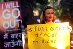 A woman holds a sign as she takes part in the #IWillGoOut rally as part of the International Women's March in Mumbai, India.