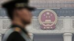 A paramilitary police officer stands guard in front of the Great Hall of the People in Beijing, China, on Friday, March 4, 2016. China's defense spending will grow at the slowest rate in at least six years as President Xi Jinping moves to trim the size of the military and the economy expands at its weakest pace in a quarter century.
