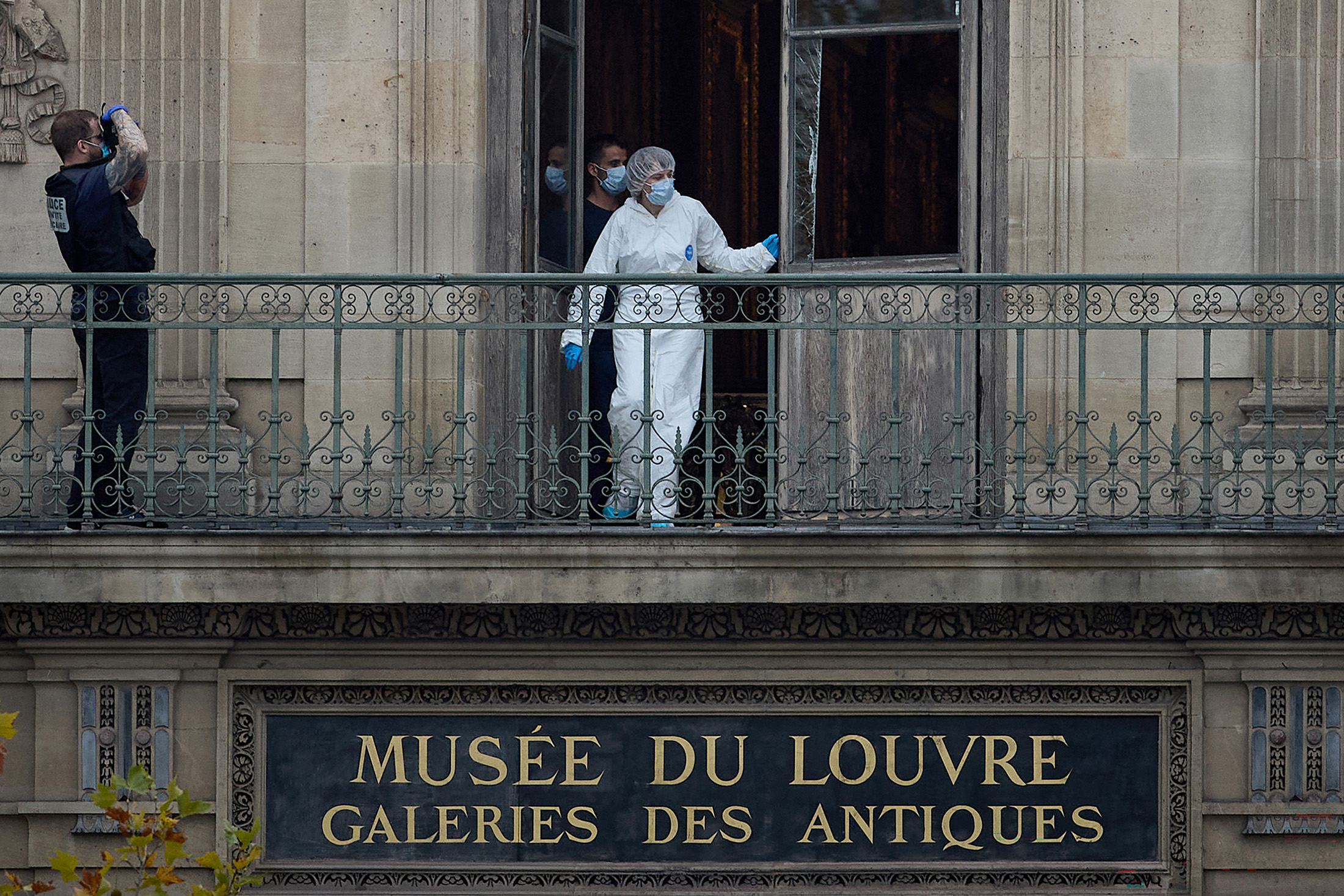 A French Forensics Officer examines the cut window and balcony of a gallery at the Louvre Museum which was the scene of a robbery on Oct. 19, 2025. Photographer: Kiran Ridley&#x2F;Getty Images