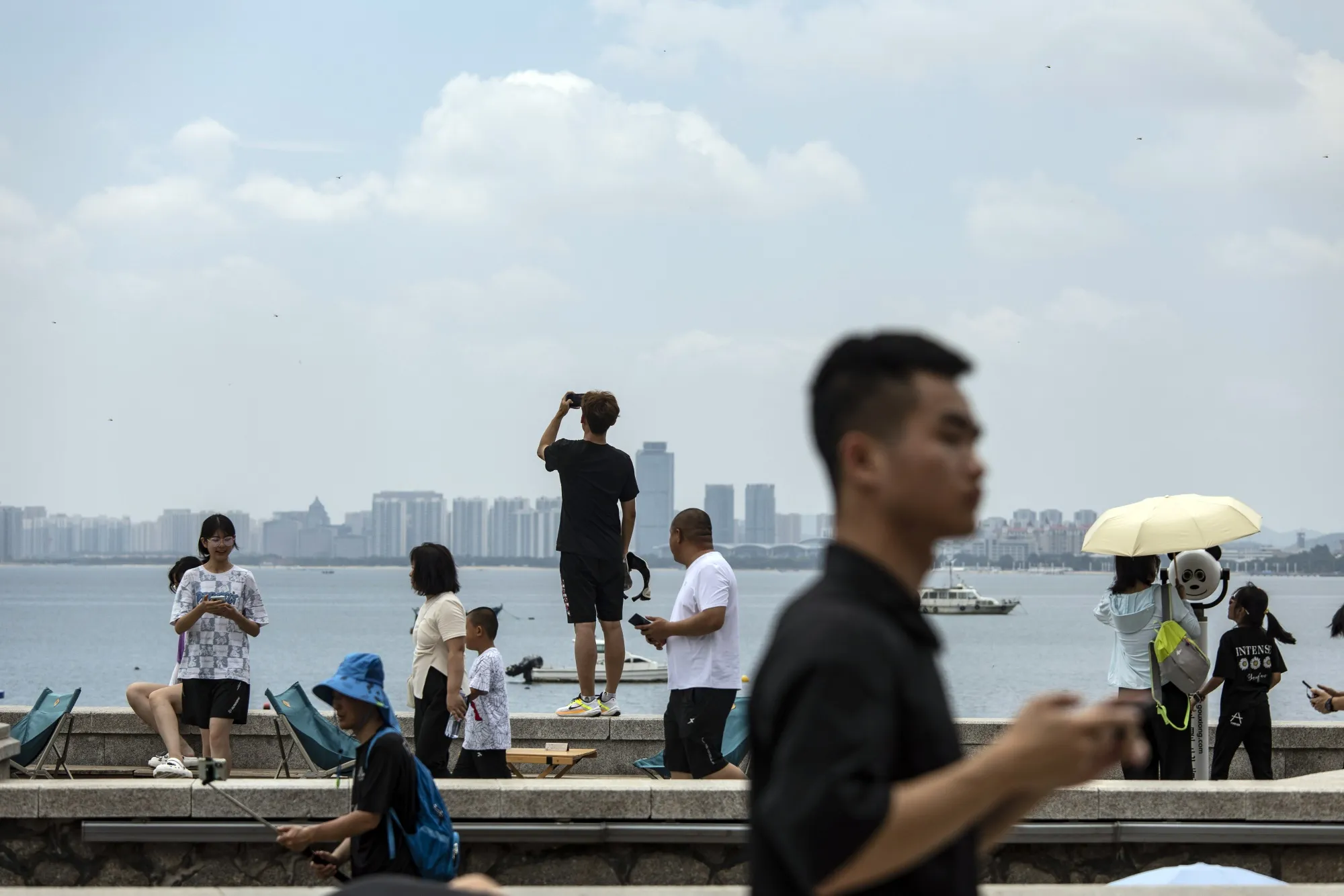 Tourists by the waterfront in Yantai, Shandong province, China, on July 14.