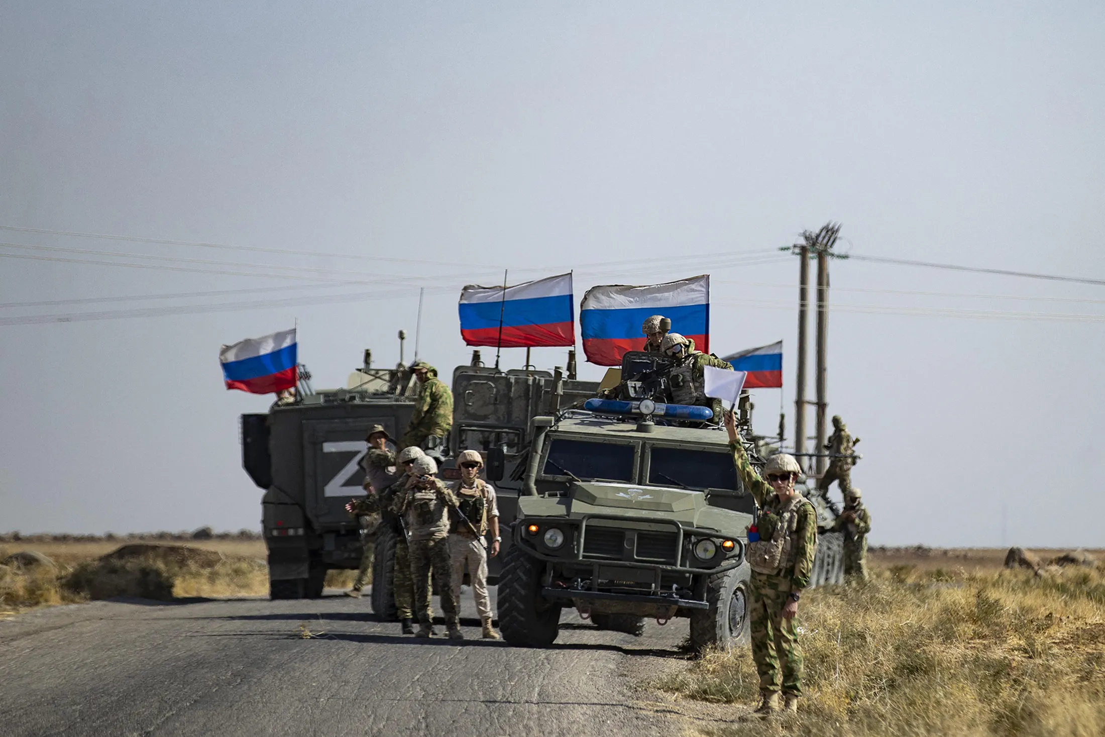 A Russian military convoy patrols a route in an oil field near Al-Qahtaniyah, Syria, on Oct. 8, 2022.