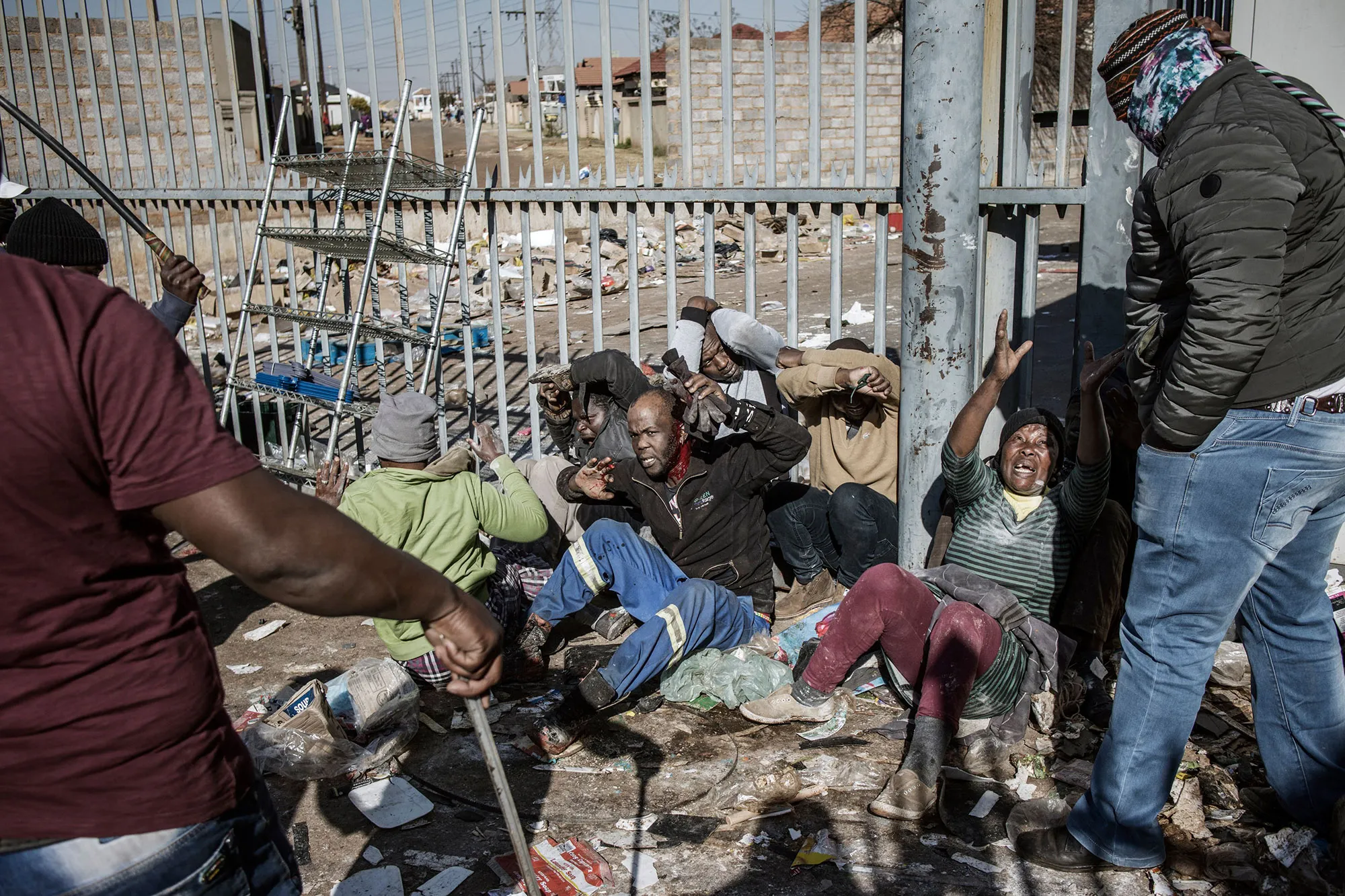A group of suspected looters are rounded up&nbsp;by a group of community vigilantes in Vosloorus, on July 14.