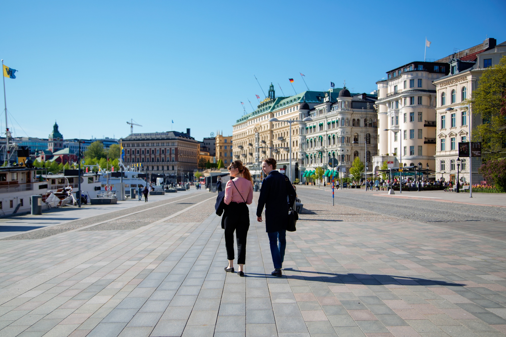 Pedestrians walk near the habour in Stockholm.
