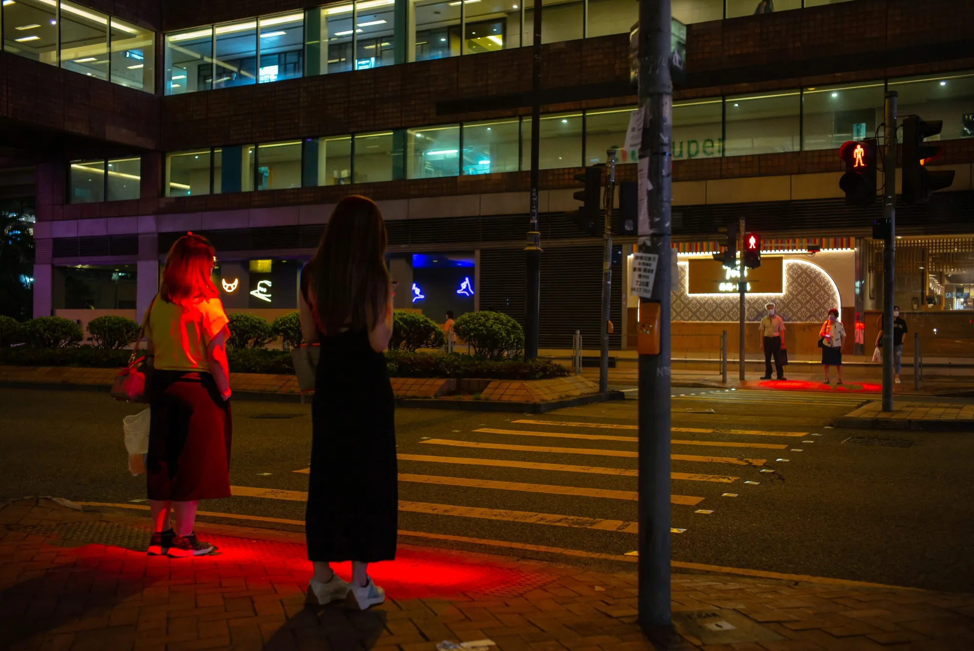 LED lights illuminate a sidewalk at a crossing point in Hong Kong.