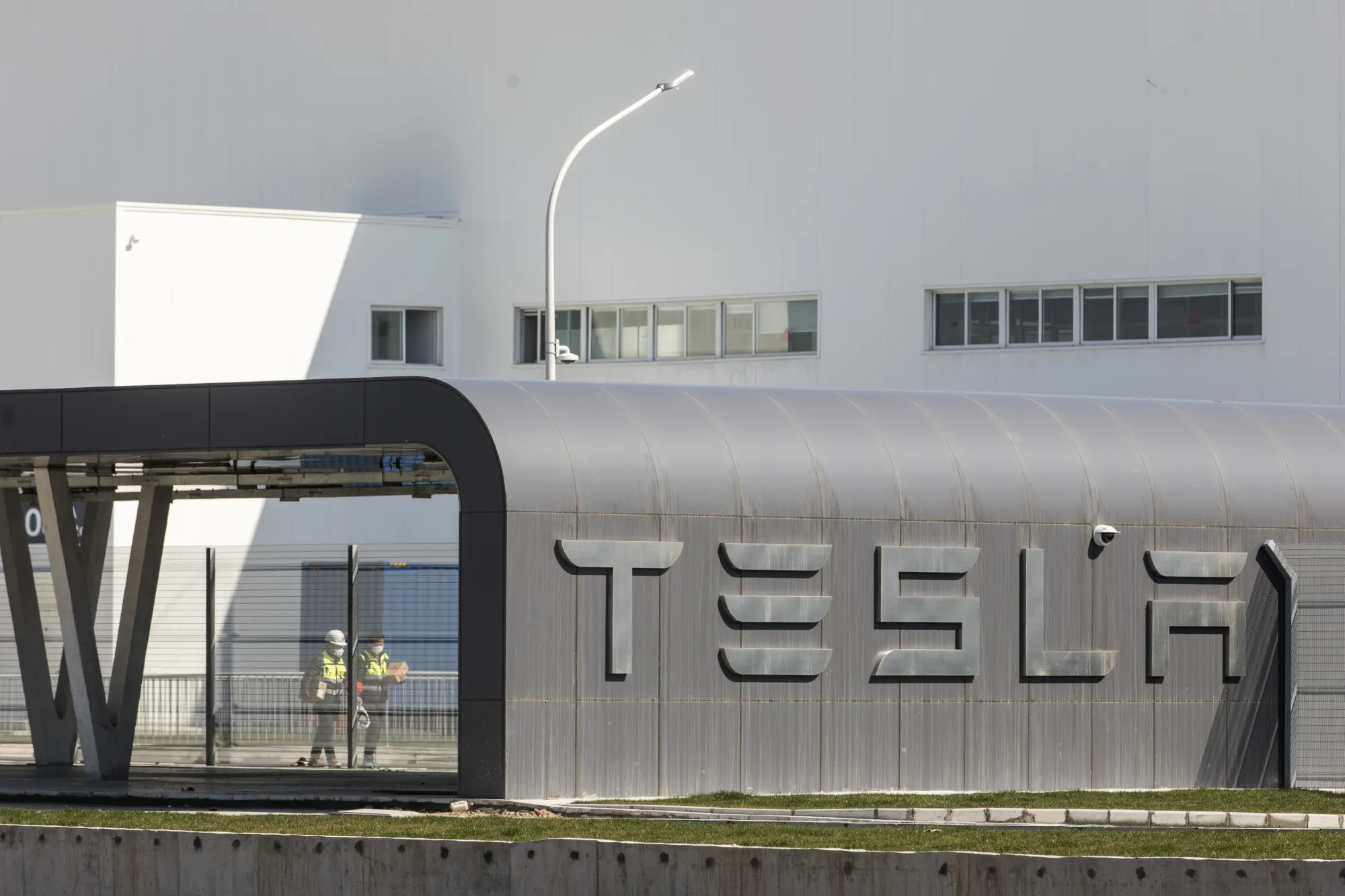 Workers walk through the Tesla Inc. Gigafactory in Shanghai, China, on&nbsp;Feb. 17, 2020.&nbsp;