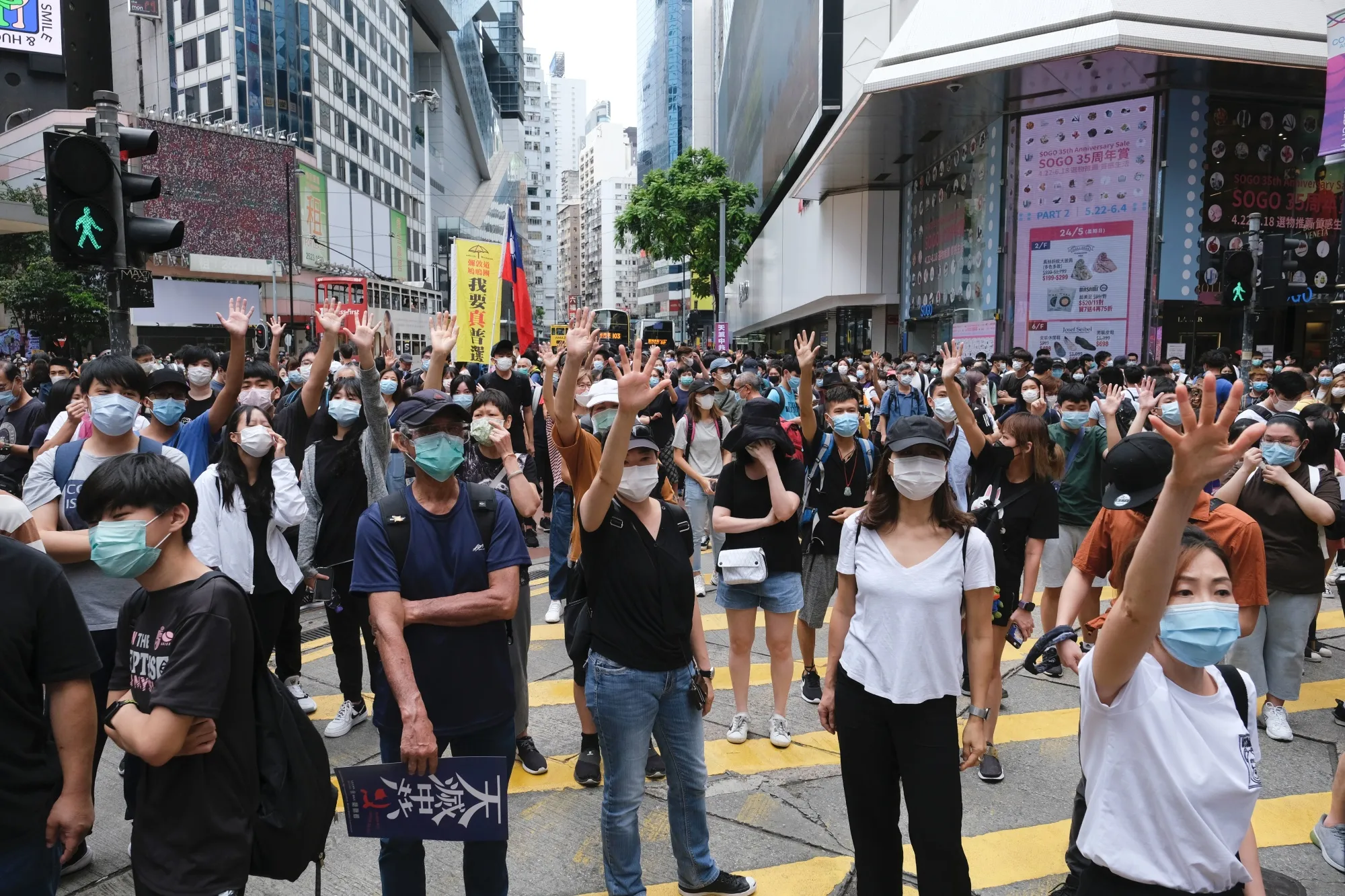 Demonstrators wearing protective masks gather during a protest in the Causeway Bay district in Hong Kong on May 24.