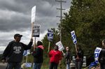 Auto Workers (UAW) strike outside the General Motors Co. (GM) plant in Romulus, Michigan, U.S., on Friday, Oct. 4.
