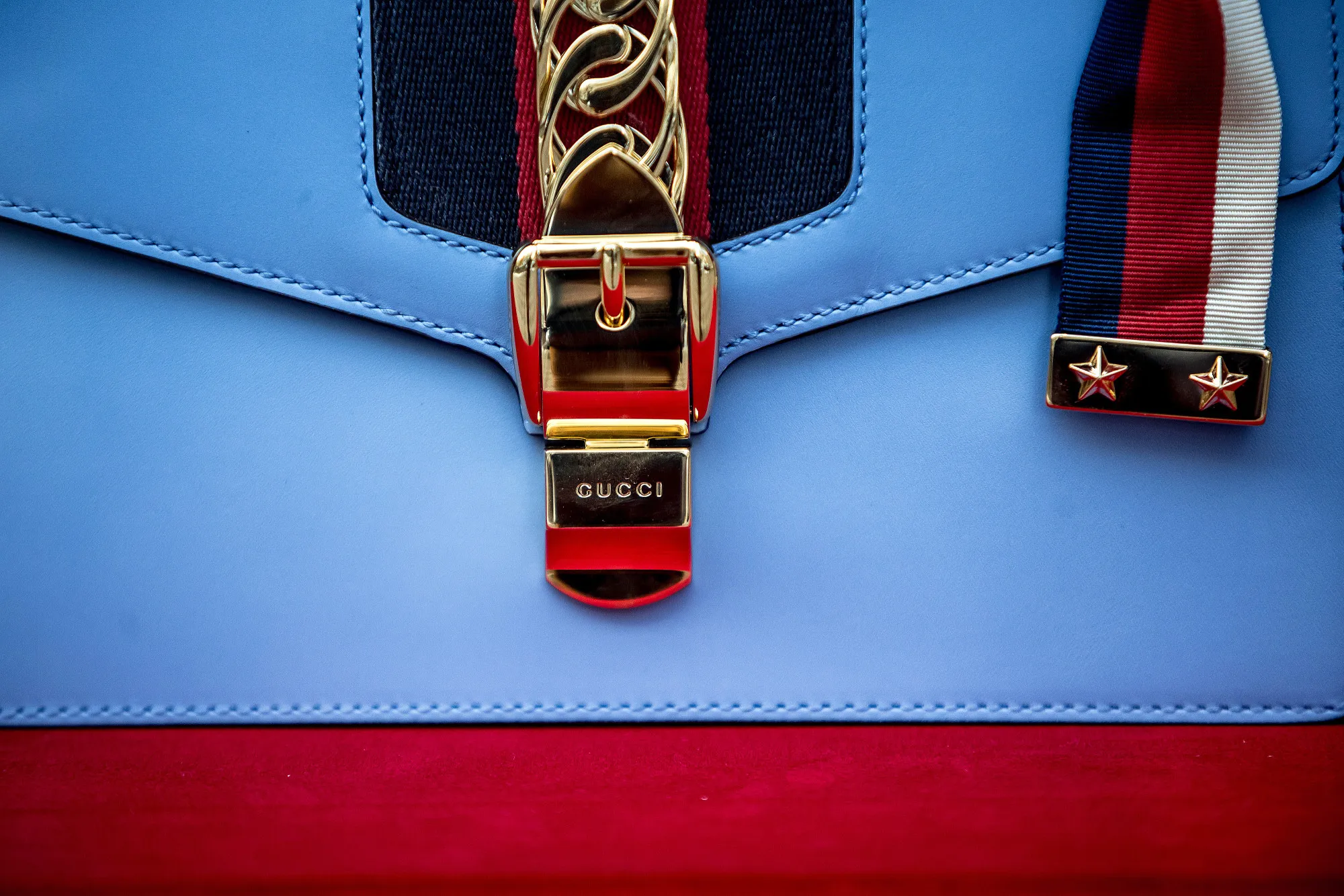 A red, white and blue leather handbag by Gucci.