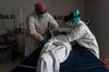 Medical staff wrap a deceased patient with bed sheets in the Covid-19 ICU at a hospital in Houston, Texas, in June. 