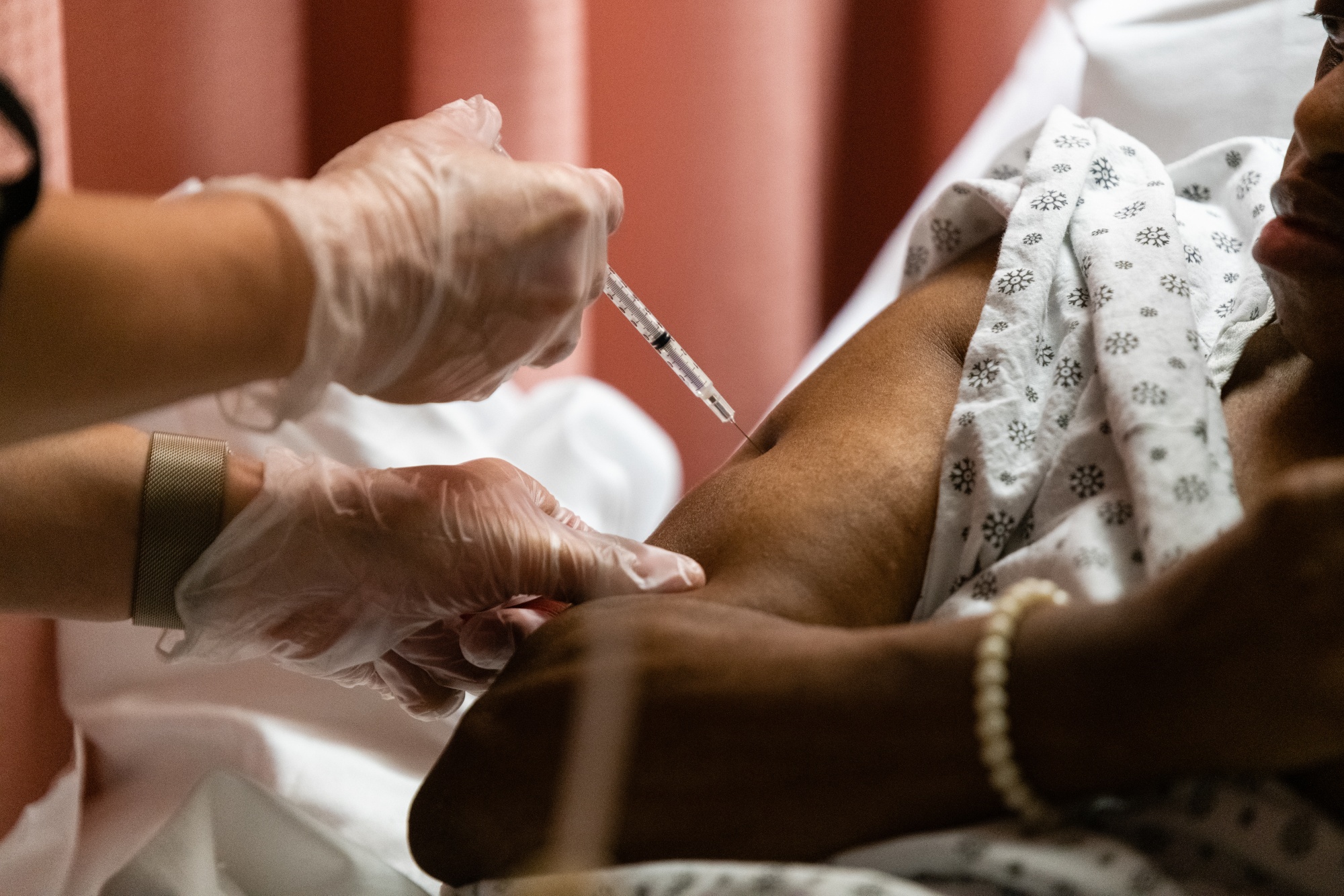 A resident of the Triboro Center nursing home in the Bronx receives a dose of the Pfizer-BioNTech Covid-19 vaccine.