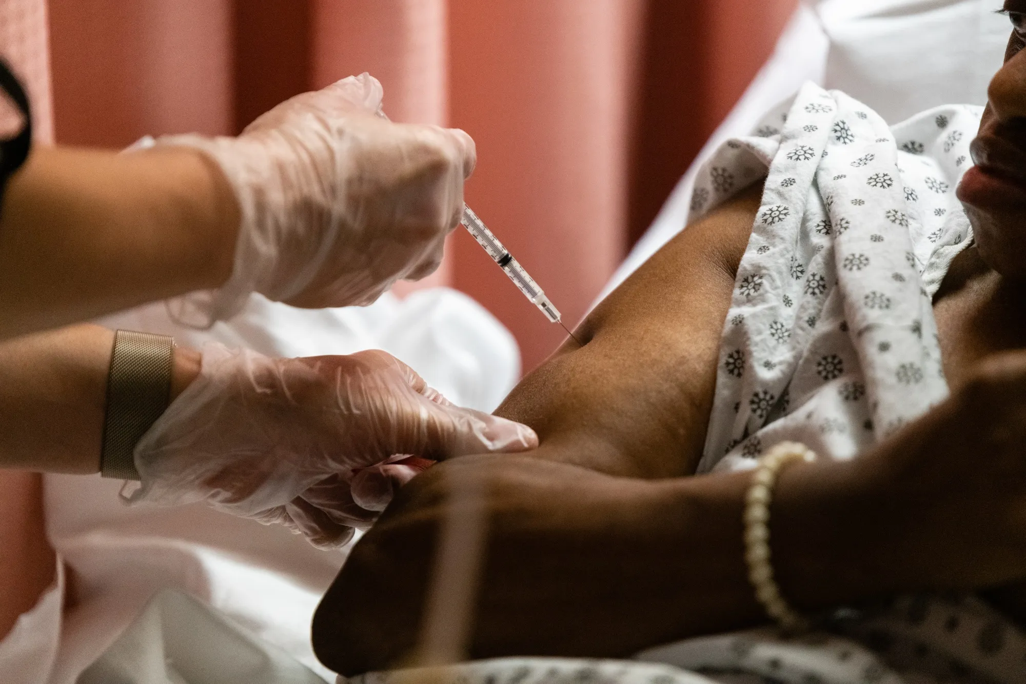 A resident of the Triboro Center nursing home in the Bronx gets a dose of the Pfizer-BioNTech Covid-19 vaccine.