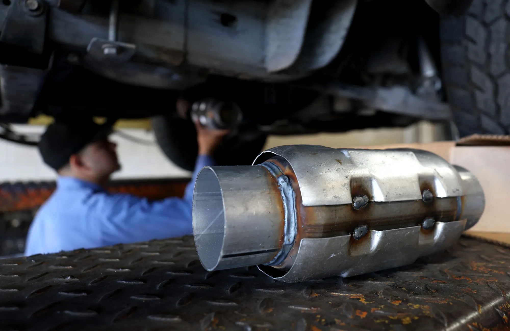 A mechanic prepares to install a catalytic converter&nbsp;onto a car in San Rafael, California.