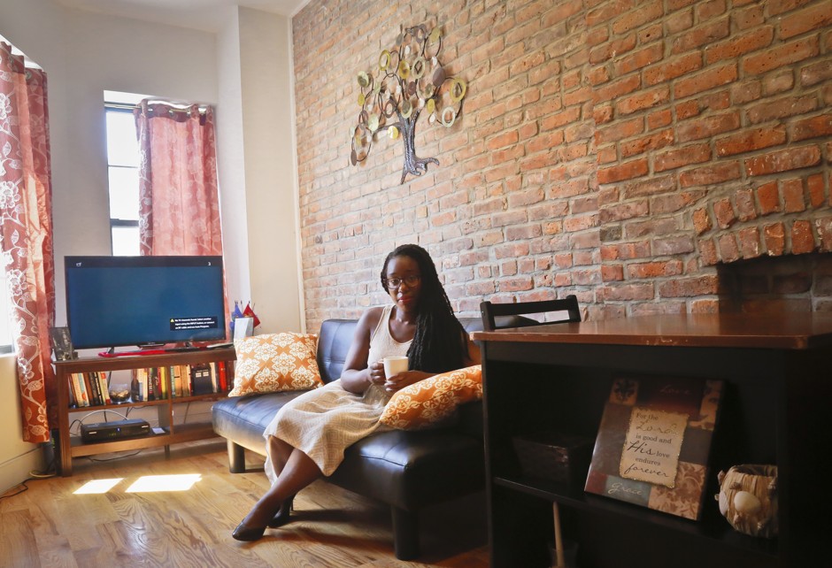 Ashley Warmington, CEO of Cozy Oasis, sits in the living room of a property that she manages listings for in New York. Warmington is partnering with the anti-racist lodging website Noirbnb.