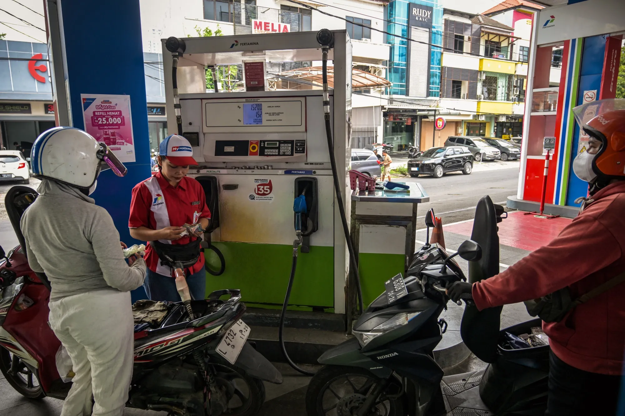 Motorcyclists at a petrol station in Surabaya, Indonesia, on March 9.