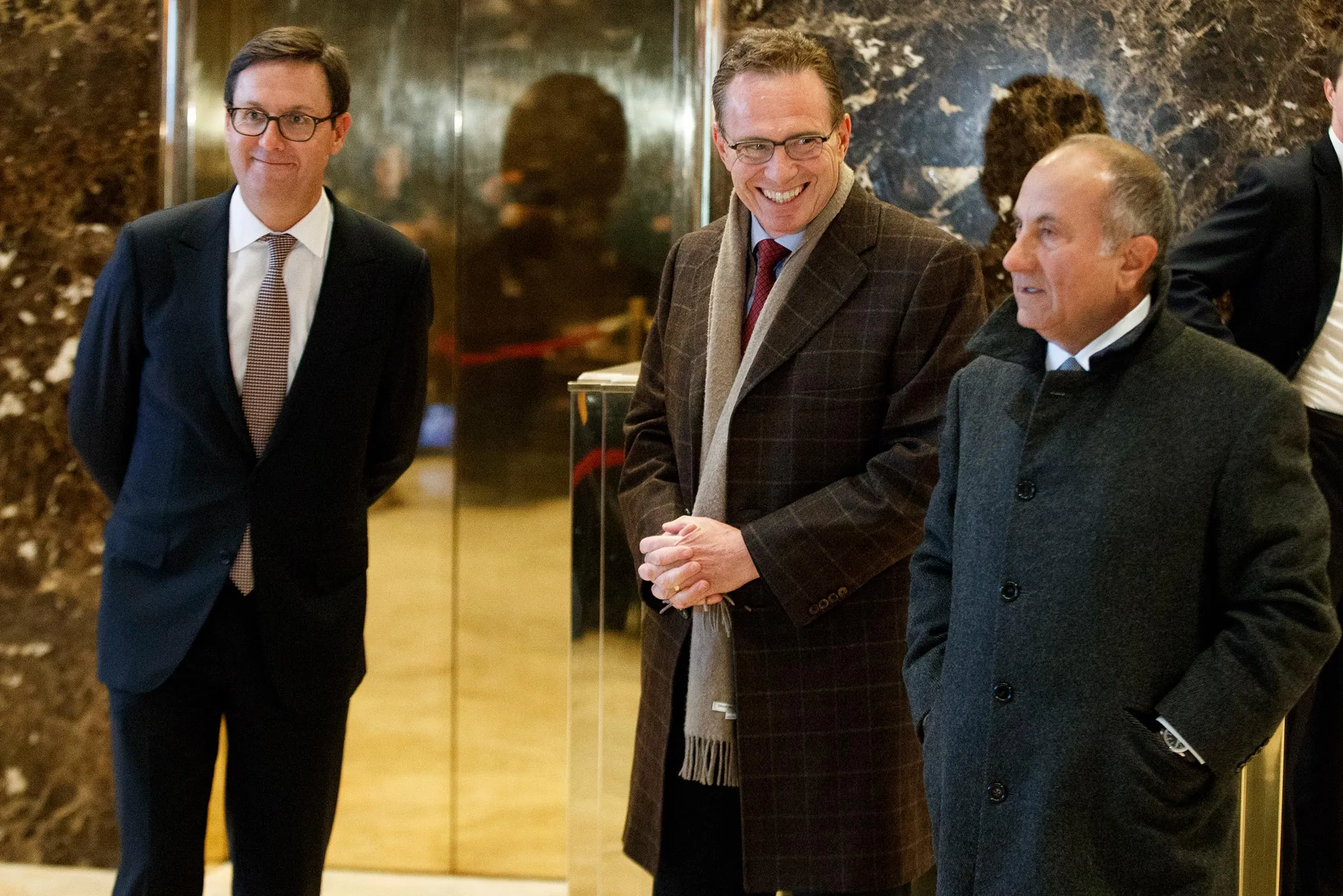 Executives from BHP Billiton Geoff Healy, from left, Andrew Mackenzie, and Jack Nasser stand in the lobby of Trump Tower in New York, on Jan. 10, 2017, before meeting with President-elect Donald Trump.
