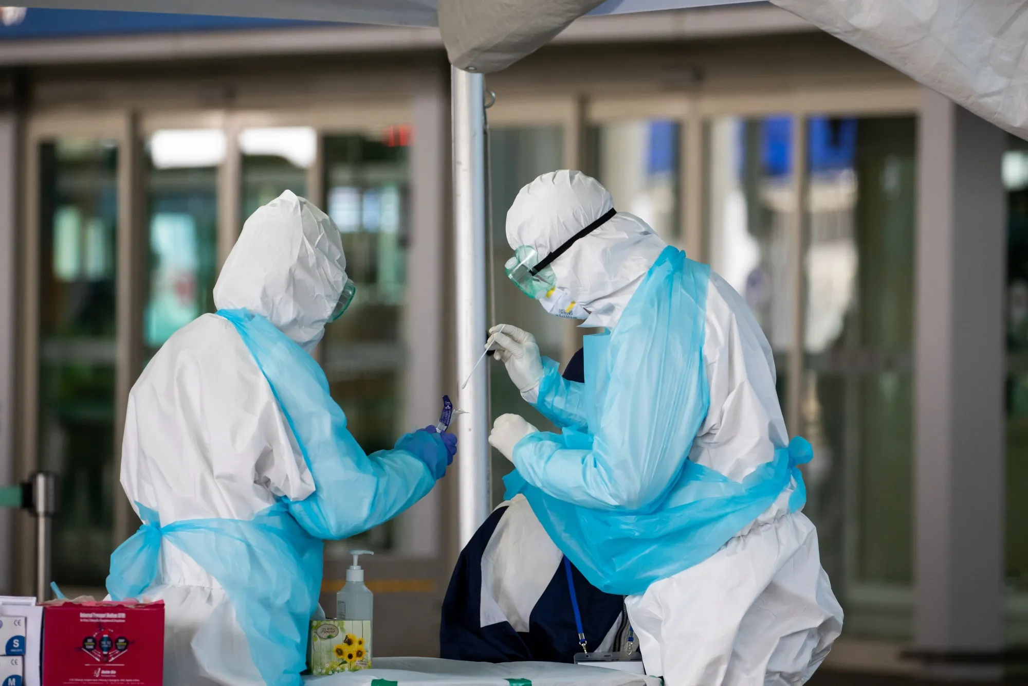 Medical staff collect a sample from an arriving passenger at Incheon International Airport in South Korea, on April 1.