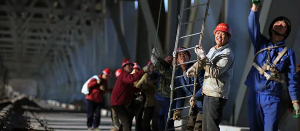 Workers labor at the construction site of the Tianxingzhou Yangtze River Bridge on January 31, 2009 in Wuhan of Hubei Province, China. 