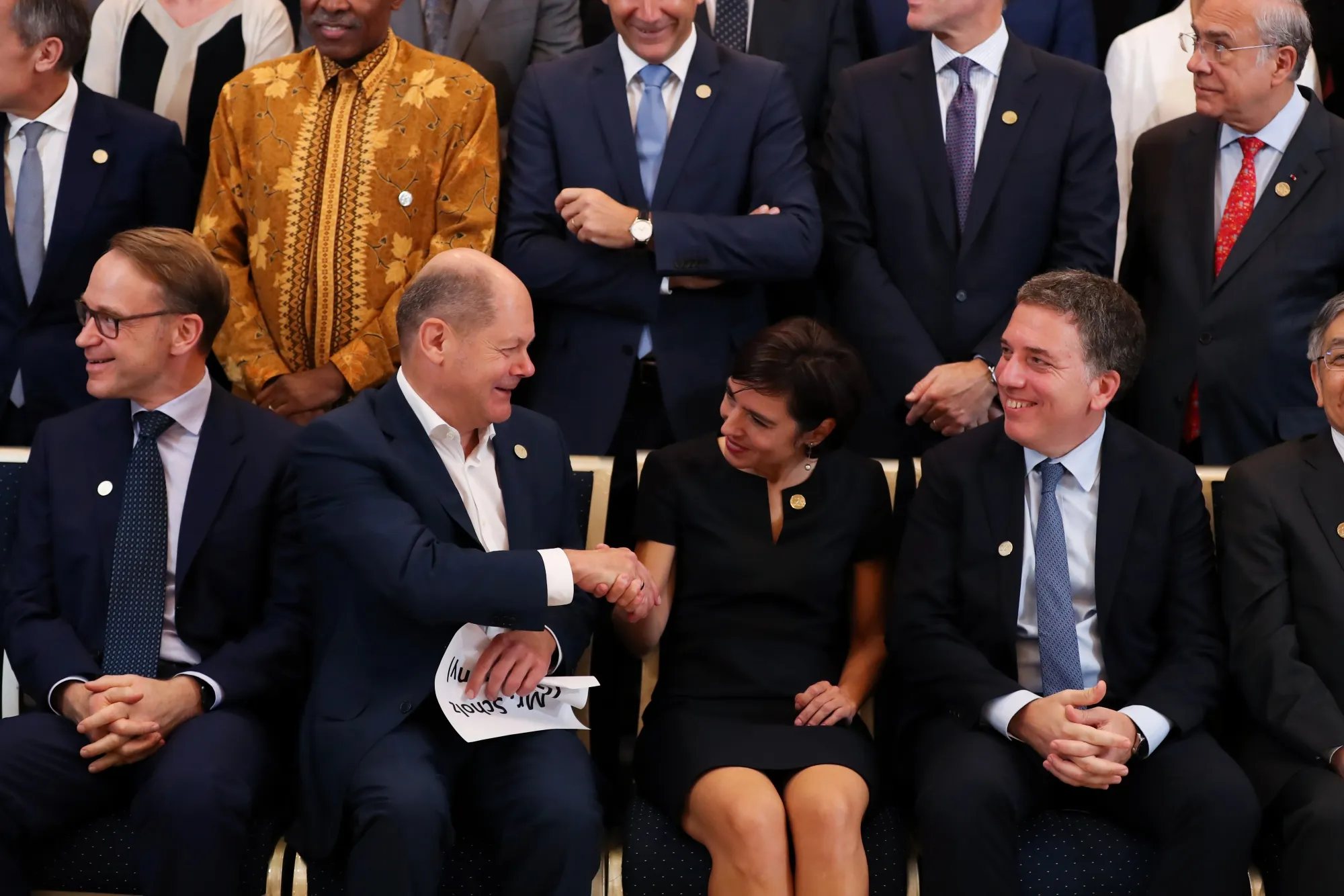 Veronica Rappoport shakes hands with Olaf Scholz, Germany’s finance minister, at the IMF fall meeting in Bali.