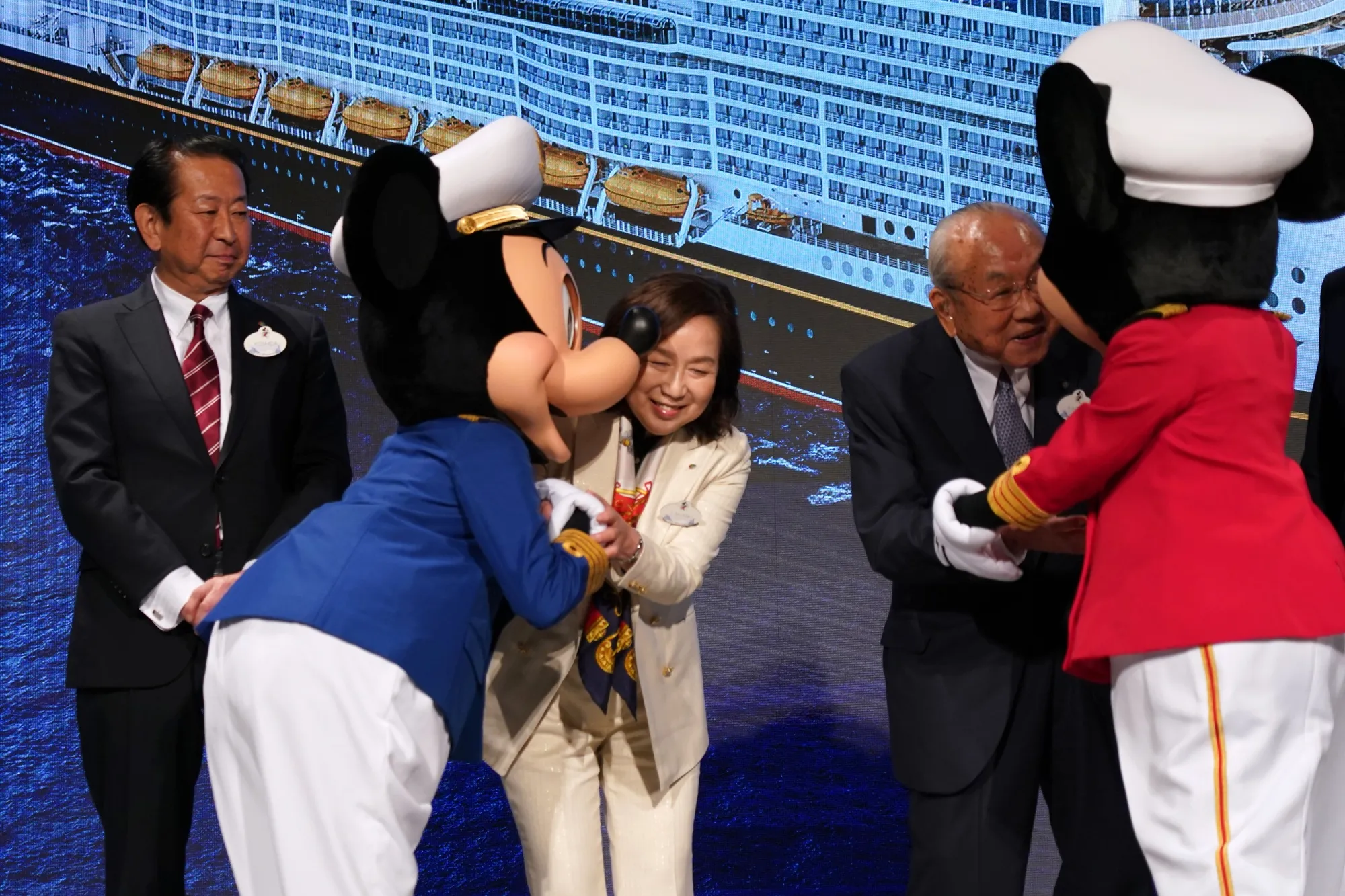Oriental Land executives, including CEO Yumiko Takano, center, with Disney characters Mickey Mouse and Minnie Mouse in Urayasu on July 9.