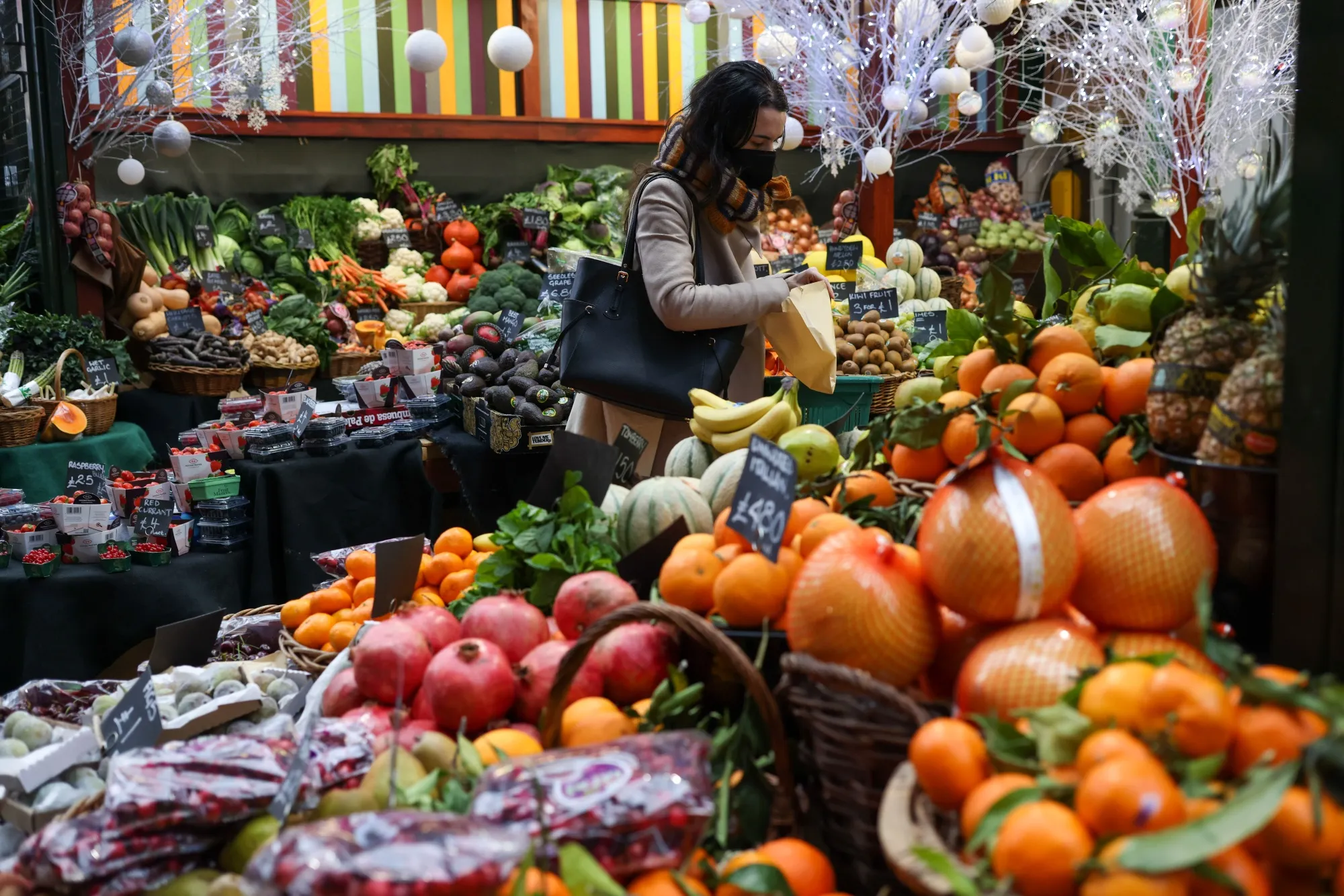 A customer shops for fresh produce at Borough Market in London, U.K.