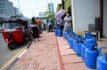 Residents wait to buy Liquefied Petroleum Gas (LPG) gas, in Colombo on March 14.