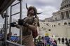  

Jacob Chansley climbs scaffolding at the U.S. Capitol building in Washington, D.C., on Jan. 6.
