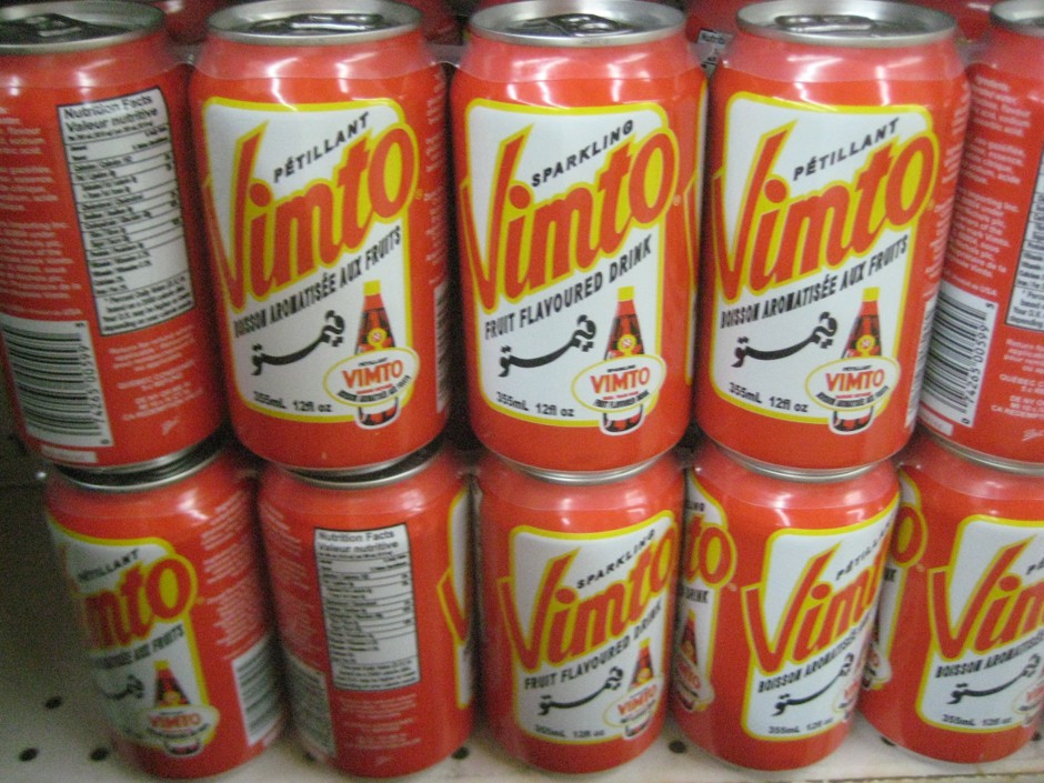 Stacked cans sport the Vimto name in English and Arabic script.