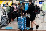 Travelers wait to check bags at the Alaska Airlines ticket counter at Hartsfield-Jackson Atlanta International Airport in Atlanta, Georgia.