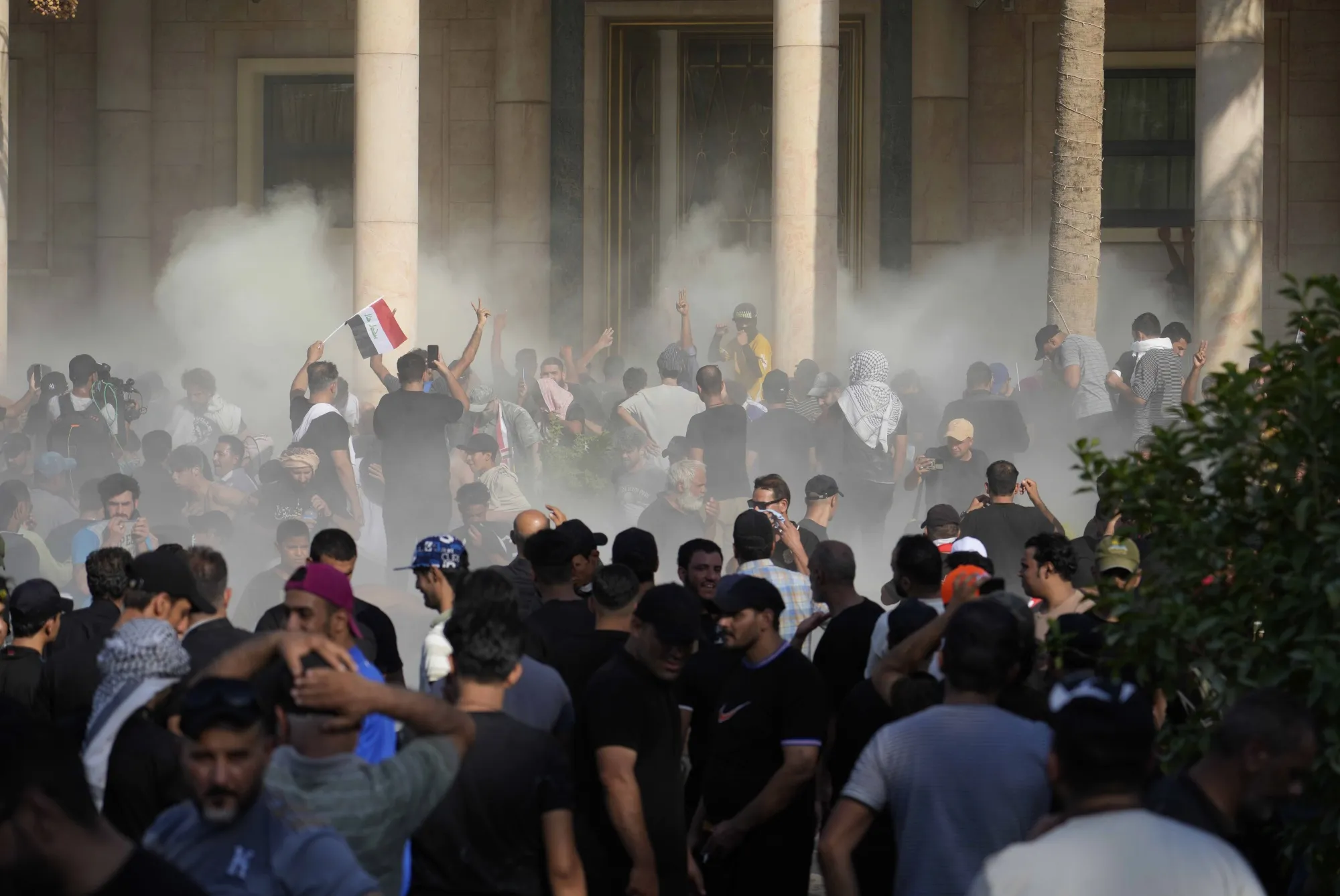 Iraqi security forces fire tear gas on followers of Shiite cleric Muqtada al-Sadr inside the government palace, in Baghdad, on Aug. 29.