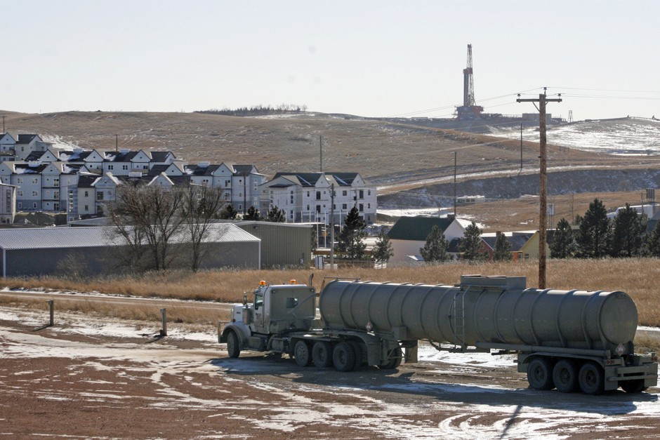 An oil truck sits in a dirt lot near a new housing development in Watford City in rural McKenzie County, North Dakota. McKenzie was the nation's fastest-growing county between 2010 and 2016 due to the Bakken oil boom.