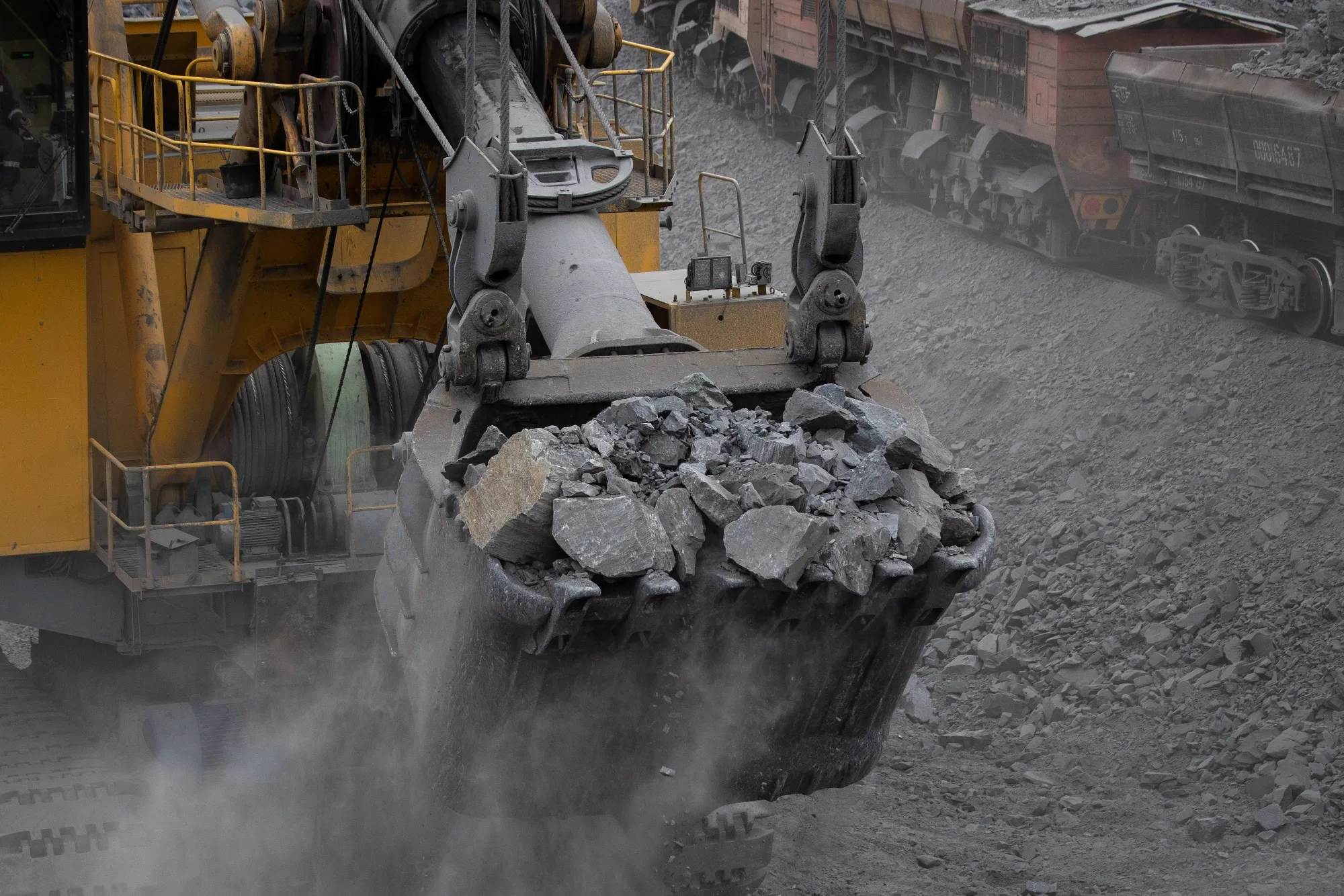 Freight train wagons are filled with mined iron ore.