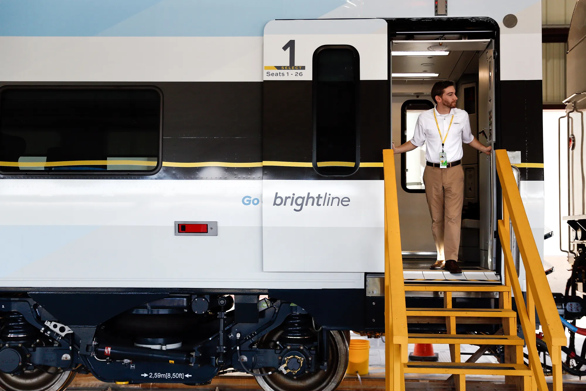 A person looks out of a Brightline train door in West Palm Beach, Florida.