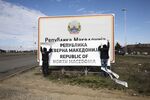Workers replace the name &quot;Republic of Macedonia&quot; with &quot;Republic of North Macedonia&quot; at the border on Feb. 13.