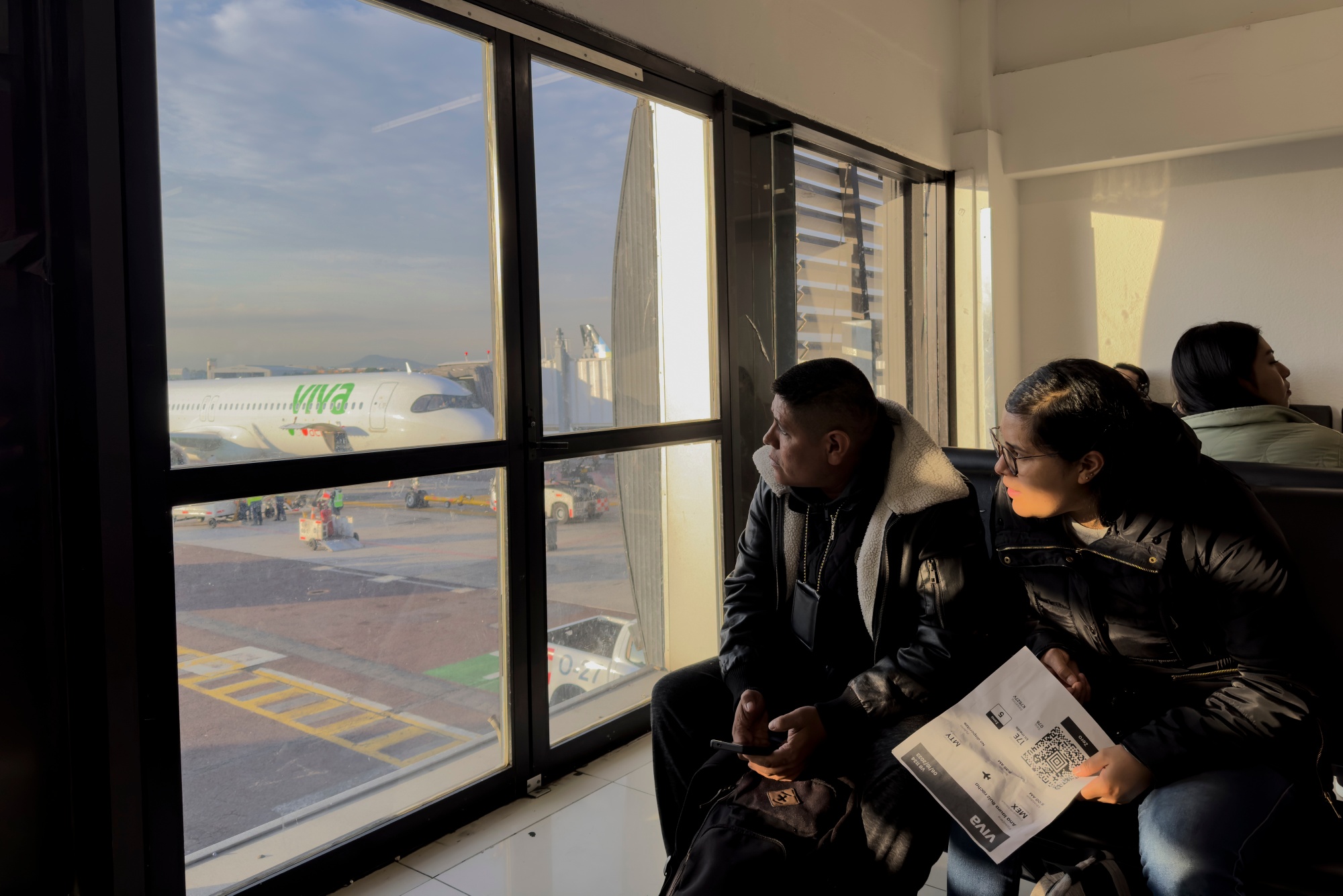 Travelers wait at the gate to board a flight at Benito Juarez International Airport in Mexico City, Mexico.