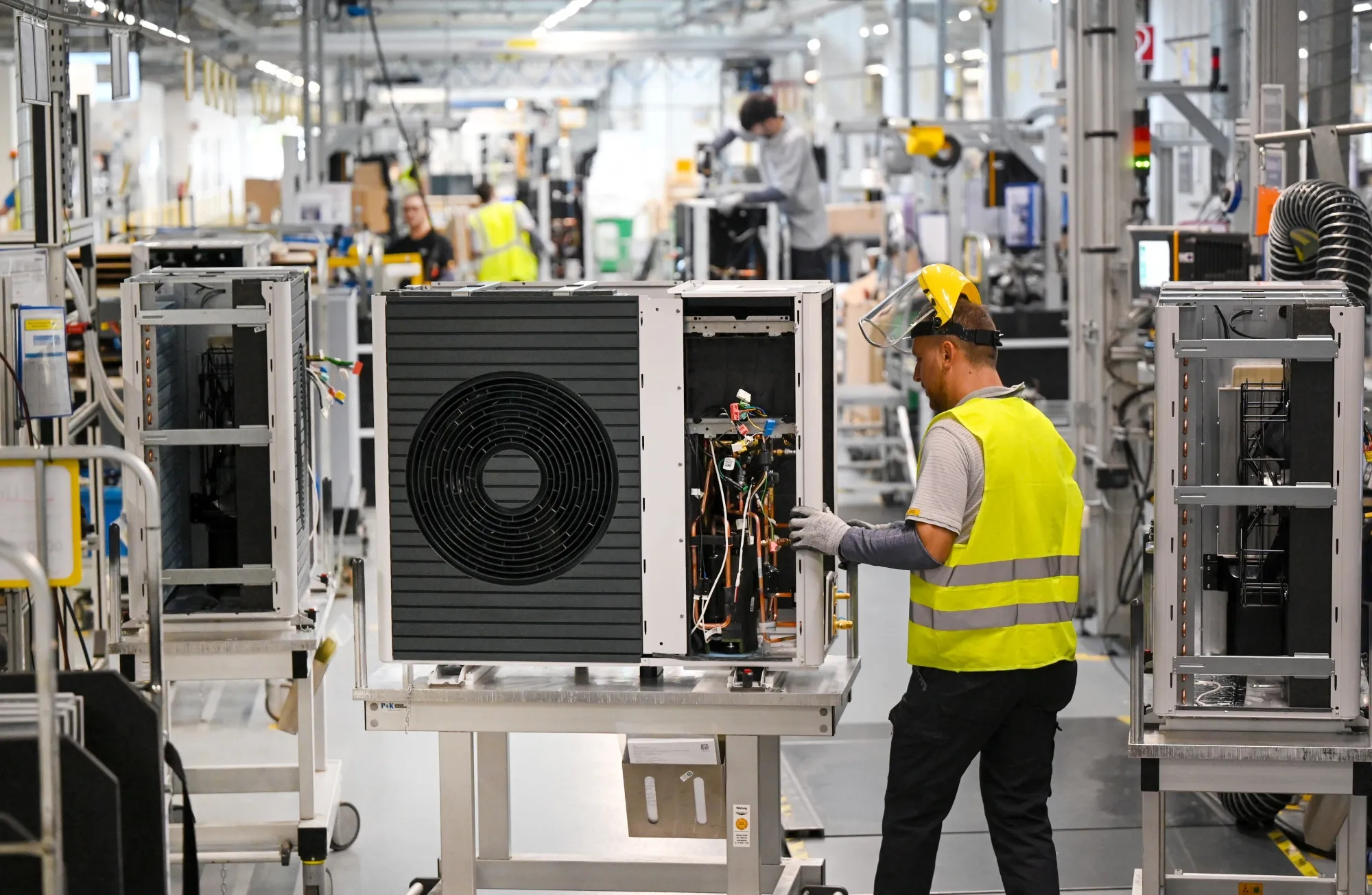 Employees assemble an air-to-water heat pump.