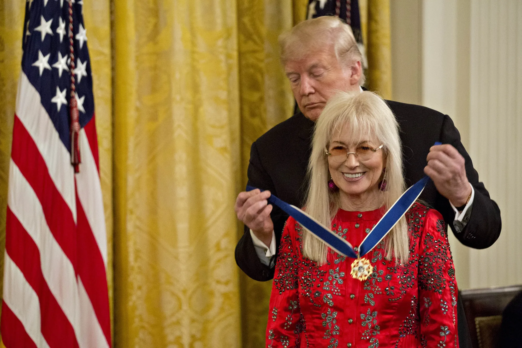 Donald Trump, back, presents Miriam Adelson with the Presidential Medal of Freedom during a ceremony in the East Room of the White House in 2018.