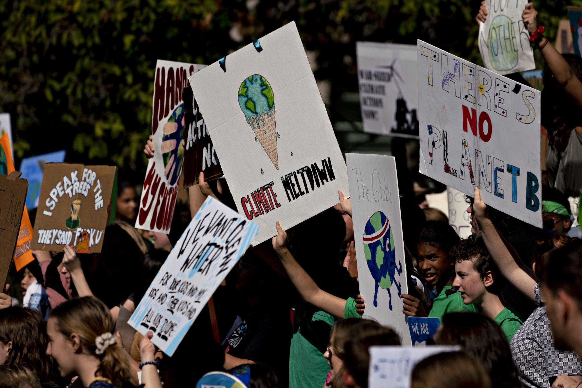 Protesters hold signs during a Global Climate Strike demonstration in Washington, D.C.
