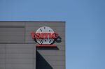 Logo at the Taiwan Semiconductor Manufacturing Co. headquarters in Hsinchu, Taiwan, on Wednesday, April 7, 2021. The TSMC is a key supplier to Apple, and it’s the iPhone maker’s commitment to become carbon neutral by 2030 that is driving much of the change throughout the supply chain.