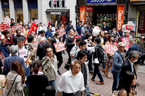 Fast-food workers protest for better payments and conditions around the Shibuya district in Tokyo on May 15