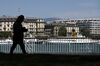 A pedestrian walks along the banks of Lake Geneva, also known as Lac Leman, in Geneva, Switzerland, on Tuesday, May 14, 2019. While the Swiss city has largely recovered from the end of secrecy at financial institutions, which shrank the number of banks there by a quarter since 2005, it faces questions about its allure for international businesses and the world’s wealthy.