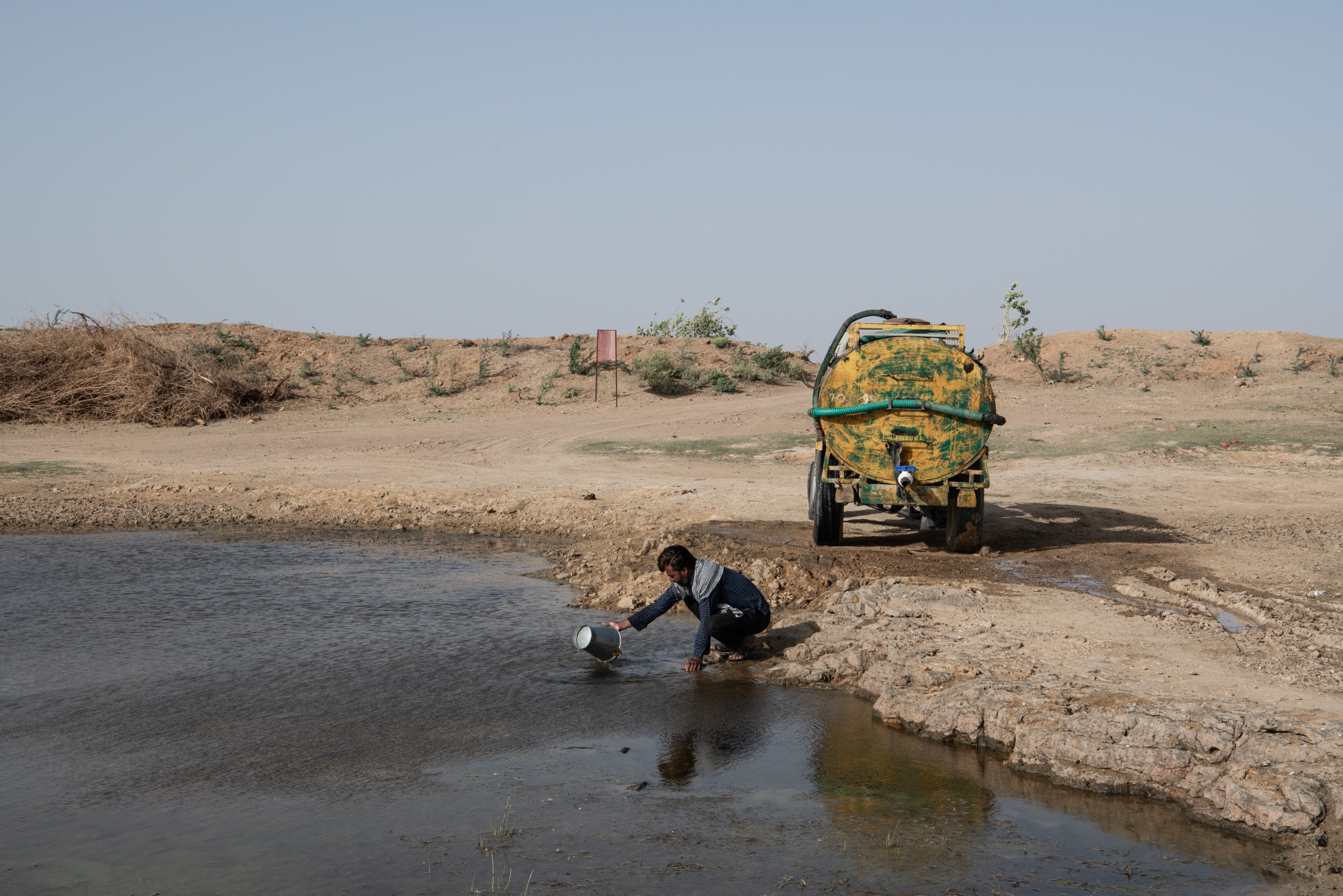 A water tanker driver at a rain-fed pond in Bhojon Ki Bap, Rajasthan, India, on March 30.