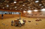A technician watches a prototype Mars rover in a simulated Mars environment at the Airbus Defence and Space company in Stevenage in April&nbsp;2016.&nbsp;