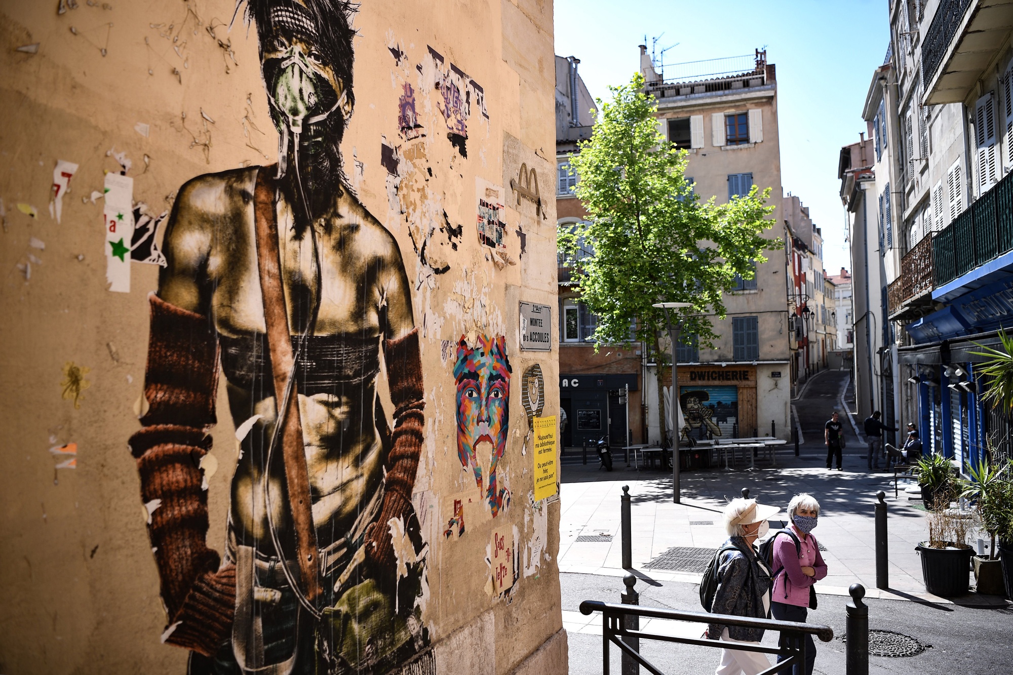 Women walk past a mural in Marseille, France, on April 25. The Green Party has taken power in the southern port city as part of a coalition.