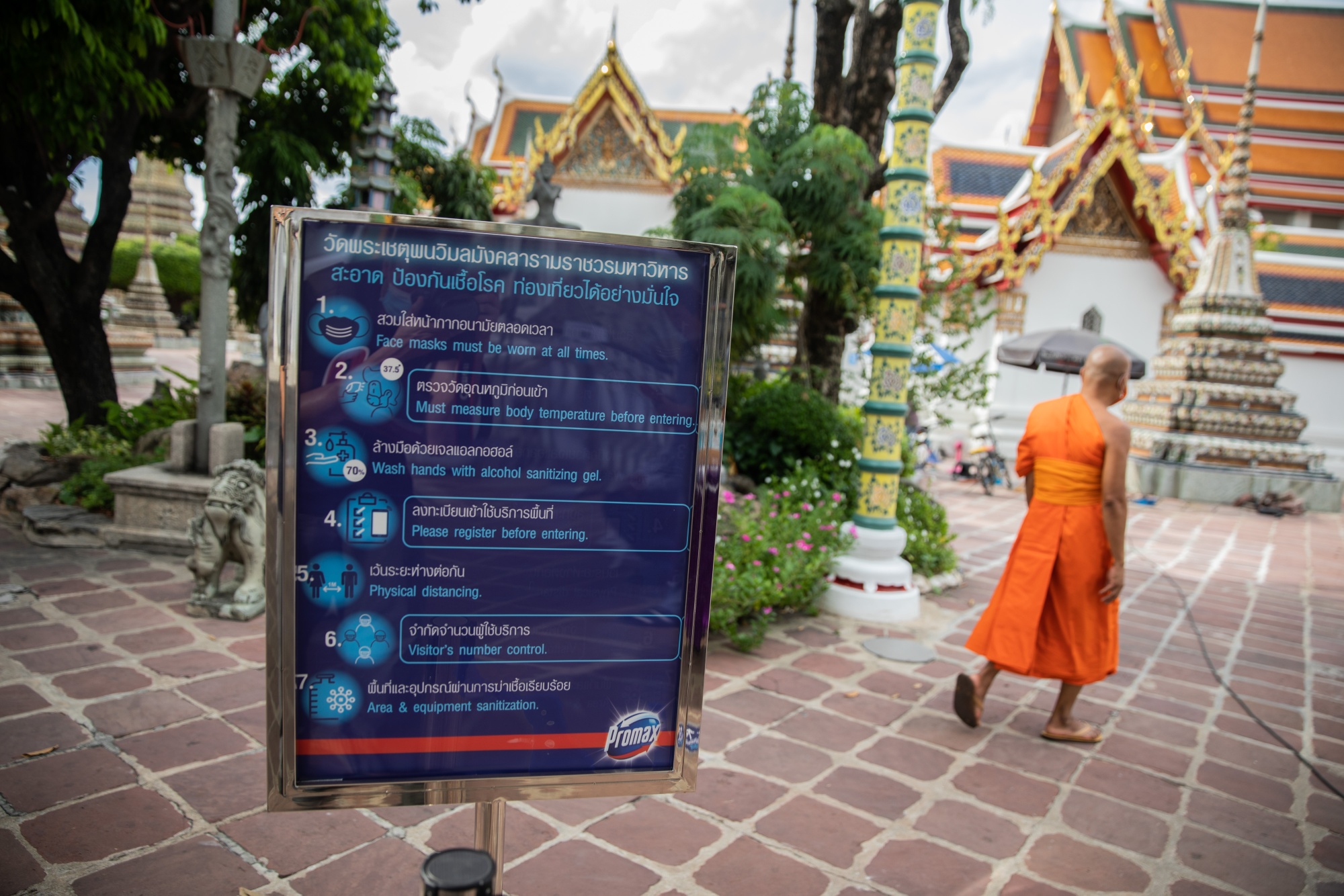 A Covid-19 information sign at Wat Pho in Bangkok, Thailand. Photograph: Taylor Weidman/Bloomberg