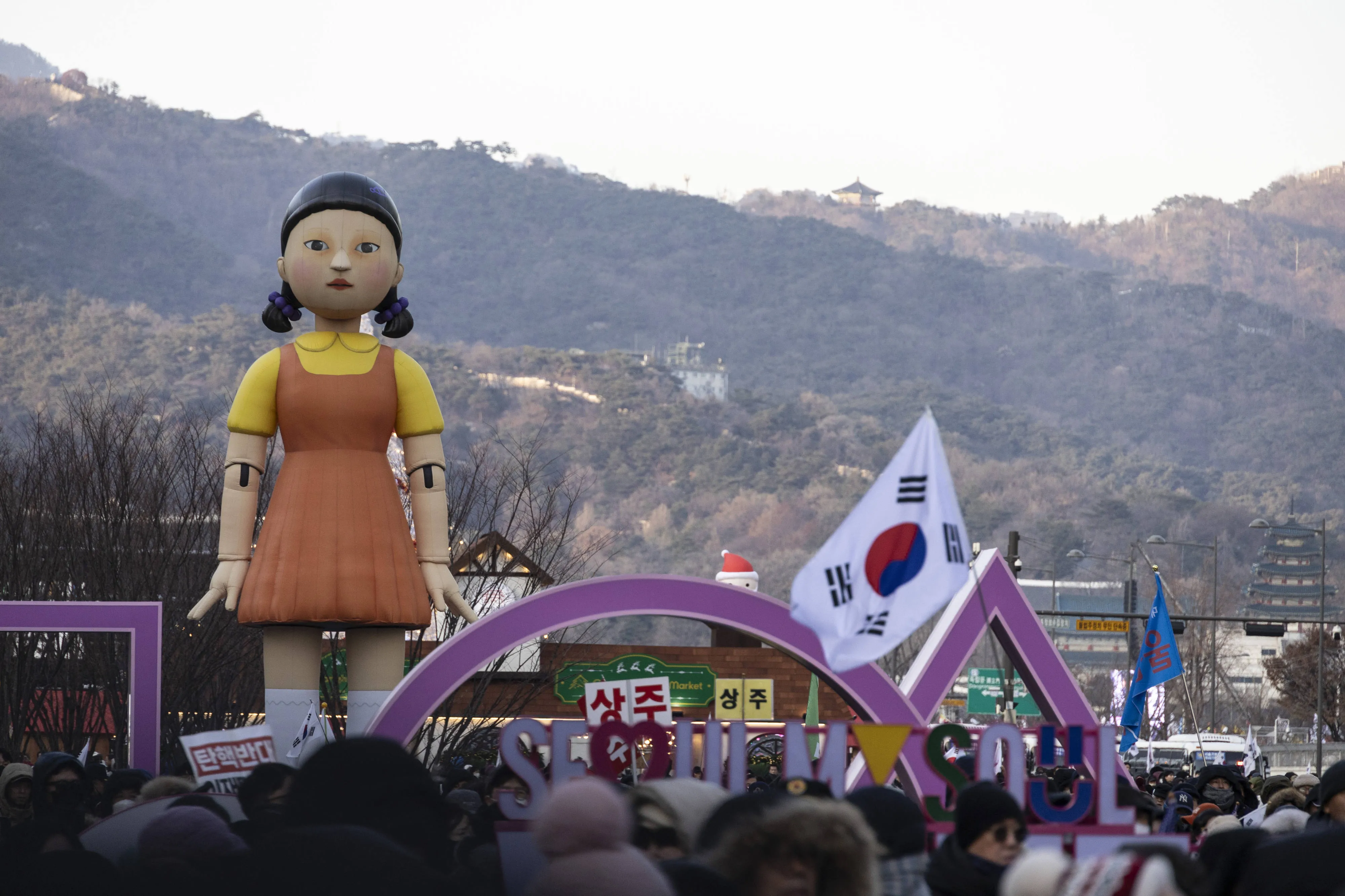Young-hee, the doll from the Netflix&nbsp;show Squid Game, standing among demonstrators who support President Yoon Suk Yeol in Seoul on Dec. 28.