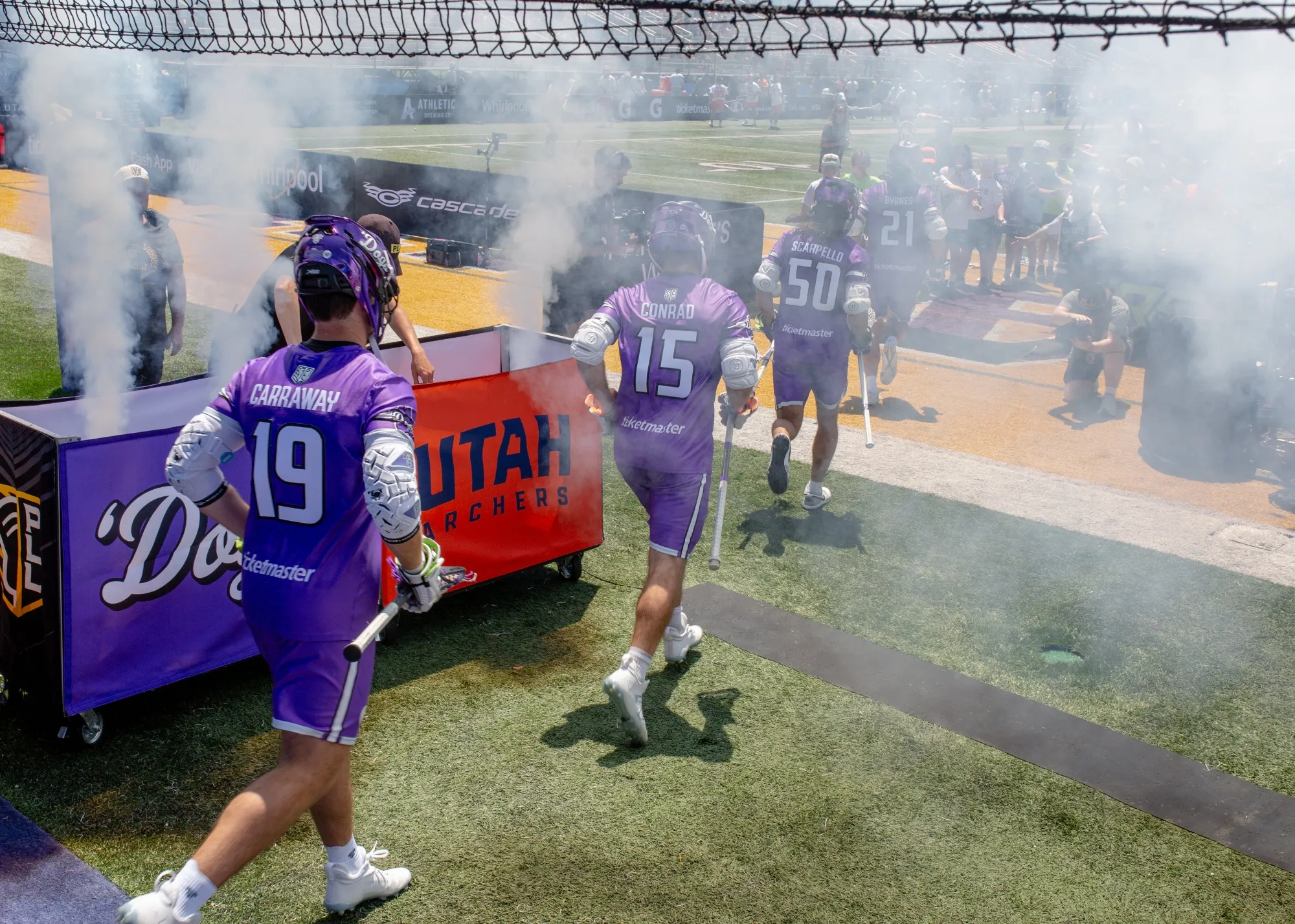 Philadelphia Waterdogs teammates, Ryan Conrad, a 27-year-old associate on the KKR &amp; Co. capital markets team, center, and Jake Carraway, a 26-year-old investment banking associate at Barclays,&nbsp;left, enter the field during the Premier Lacrosse League (PLL) opening game against the Utah Archers at Tom &amp; Mary Casey Stadium-SUNY Albany in Albany, on June 1.