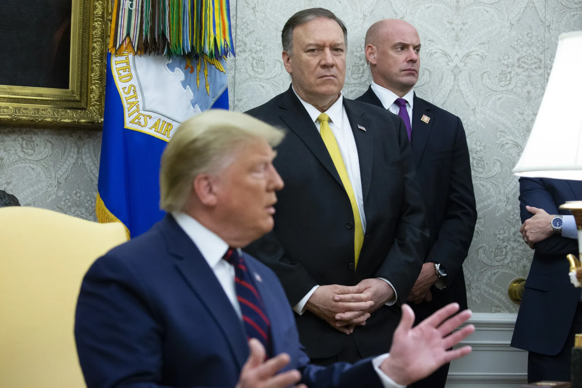 Mike Pompeo listens as U.S. President Donald Trump speaks Oct. 16.