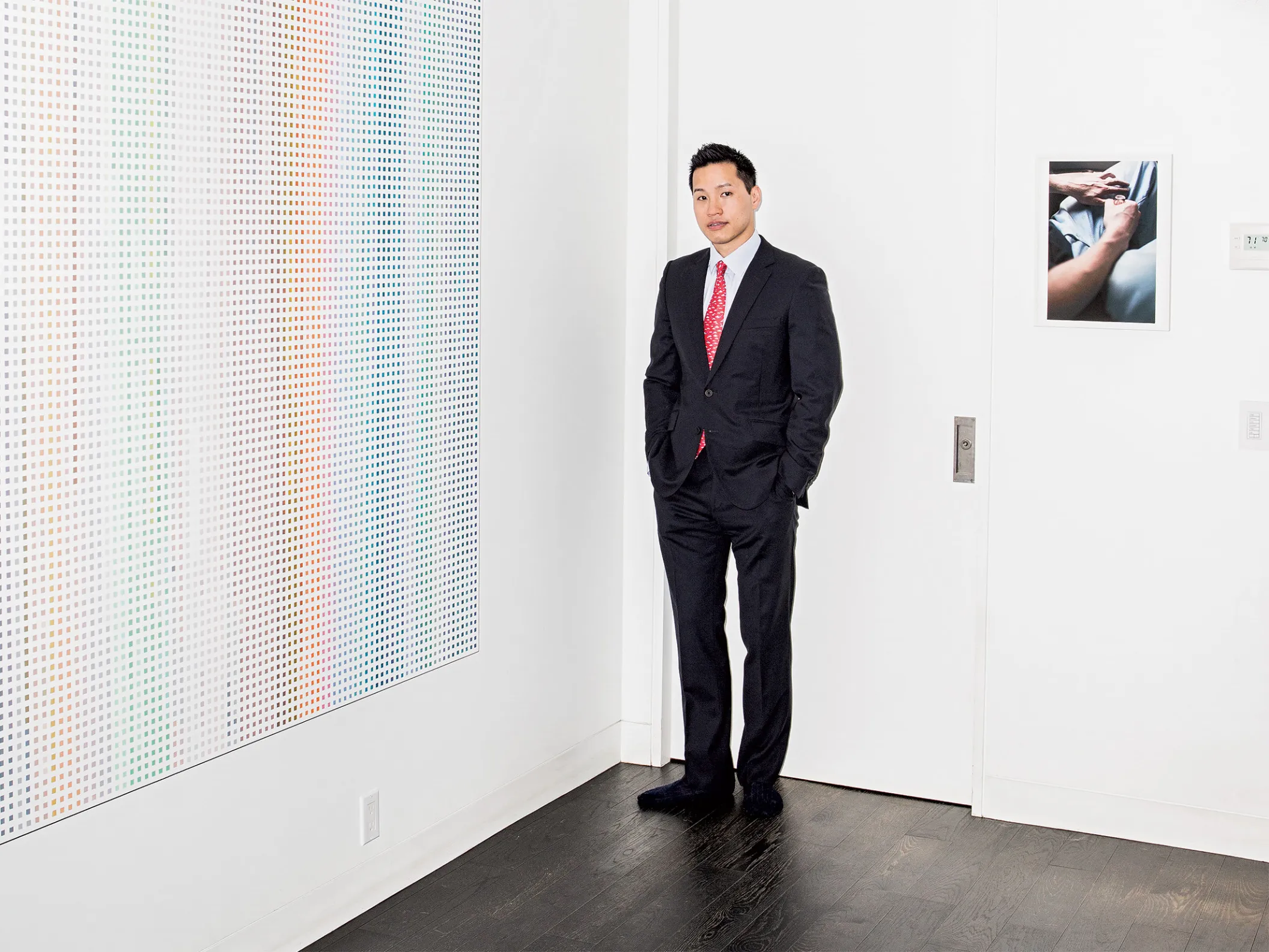 Leong in front of works (from left) by Cheyney Thompson and Wolfgang Tillmans.
