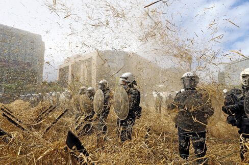 Police in Brussels confront protesting farmers who want relief from falling prices.